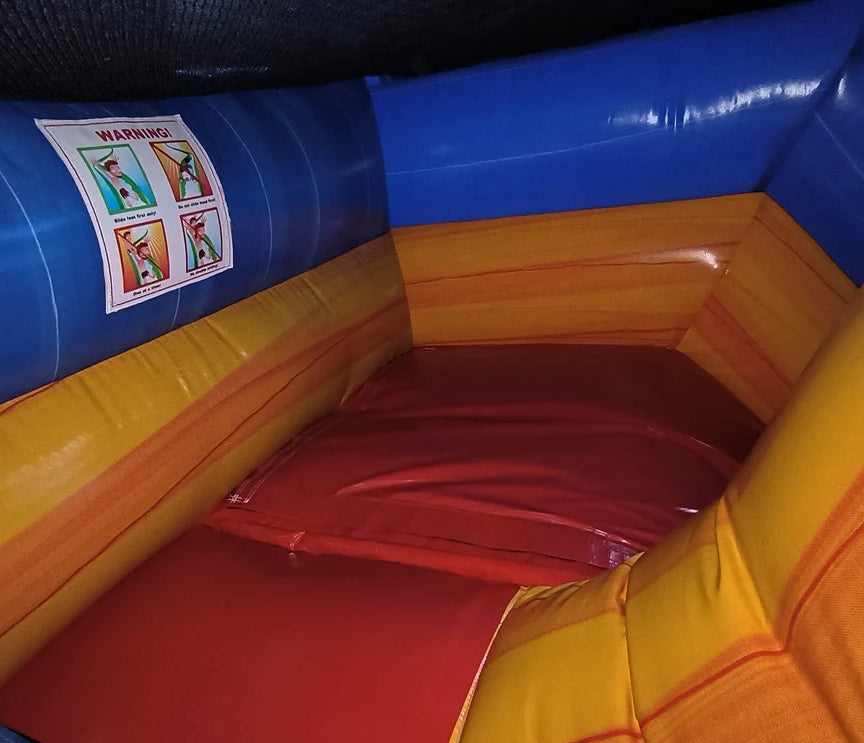 Colorful inflatable bounce house with warning labels